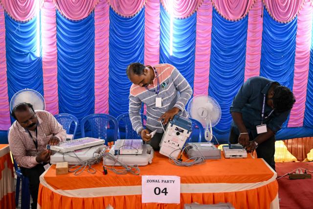 Poll officials prepare and install candidate names and symbols in Electronic Voting Machines (EVMs) in Chennai on April 16, 2026 ahead of the Tamil Nadu Legislative Assembly election. (Photo by R. Satish BABU / AFP)