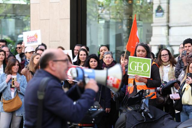 Employees of the leading magazine publisher in France Prisma Group gather during a demonstration against the Employment Protection Plan (PSE) in front of a building of the Prisma Media Group in Paris on April 16, 2026. Prisma Group announced to staff representatives on March 30, 2026 a plan to cut 261 jobs, representing 40% of its workforce, according to the CGT union. (Photo by ALAIN JOCARD / AFP)