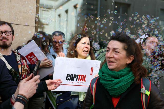 Employees of the leading magazine publisher in France Prisma Group gather during a demonstration against the Employment Protection Plan (PSE) in front of a building of the Prisma Media Group in Paris on April 16, 2026. Prisma Group announced to staff representatives on March 30, 2026 a plan to cut 261 jobs, representing 40% of its workforce, according to the CGT union. (Photo by Alain JOCARD / AFP)