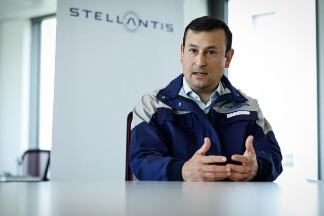 Éric Haan, director of the Stellantis Poissy plant addresses media during a press conference at the Stellantis multinational car manufacturer's plant in Poissy, west of Paris on April 16, 2026. Automaker Stellantis will cease automobile production at its historic Poissy plant (Yvelines) after 2028. The site will be converted into a parts manufacturing and vehicle dismantling center, retaining 1,000 of the current 2,000 jobs, the group announced on April 16, 2026. (Photo by Simon Wohlfahrt / AFP)