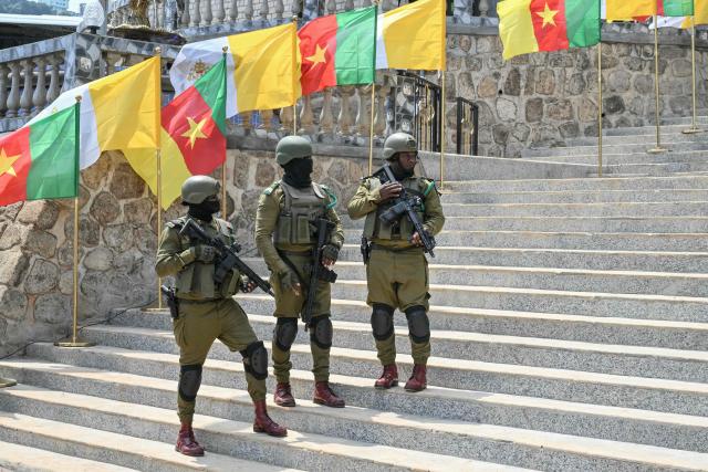 Cameroonian soldiers stand guard ahead of the arrival of Pope Leo XIV at Saint Joseph's Cathedral in Bamenda, on the fourth day of an 11-day apostolic journey to Africa, on April 16, 2026. (Photo by Alberto PIZZOLI / AFP)