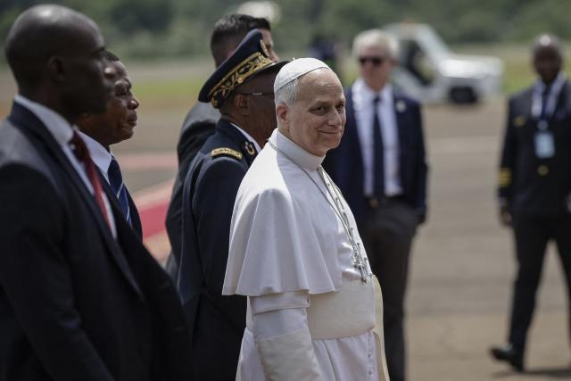 Pope Leo XIV (C) looks on upon his arrival at Bamenda Airport in Bamenda, on the fourth day of an 11-day apostolic journey to Africa, on April 16, 2026. (Photo by Patrick MEINHARDT / AFP)