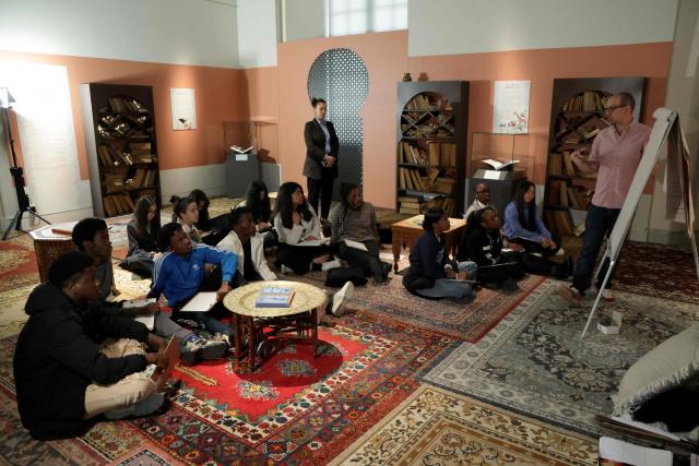 Students take part in a comic book workshop at the International City of French Language (Cite Internationale de la Langue Francaise) during a visit of French President to promote 'disconnecting' and 'reading' as alternatives to screens as part of his fight to ban social networks for the youngest in the castle of Villers-Cotterets, northern France on April 16, 2026. In response to the explosion in screen time among 6- to 17-year-olds and the impact of algorithms on our children, Emmanuel Macron has pledged to ban social media for those under 15. (Photo by Ludovic MARIN / POOL / AFP)