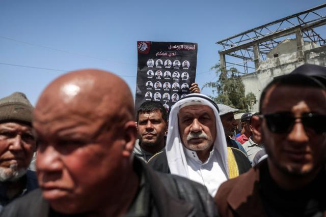 Demonstrators march to mark Palestinian Prisoner's Day during a protest against recently-approved Israeli law allowing the execution of Palestinians convicted on terror charges for deadly attacks, in Khan Younis on April 16, 2026. Under the new law, passed in parliament late on March 30, Palestinians in the West Bank convicted by military courts of carrying out deadly attacks classified as "terrorism" will face the death penalty as a default sentence. Because Palestinians in the territory are automatically tried in Israeli military courts, the measure effectively creates a separate and harsher legal track. (Photo by BASHAR TALEB / AFP)