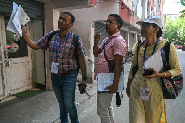 Census enumerators collect details of housing and amenities during the first phase of the census, in New Delhi on April 16, 2026. India launched the world's largest census on April 1, with more than three million officials to take part in a vast counting exercise over the next year. (Photo by Arun SANKAR / AFP)