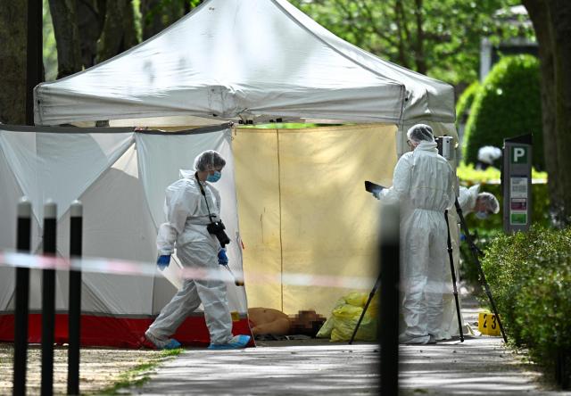 EDITORS NOTE: Graphic content / Police forensic personnel work beside a tent covering the body of French businessman Eric Robic in Neuilly-sur-Seine on the outskirts of Paris on April 16, 2026. A businessman known for fraud was shot dead in broad daylight in the middle of the street in Neuilly-sur-Seine (Hauts-de-Seine), an upscale suburb in western Paris, AFP learned from a source close to the case, confirming a report by Le Parisien. (Photo by JULIEN DE ROSA / AFP)