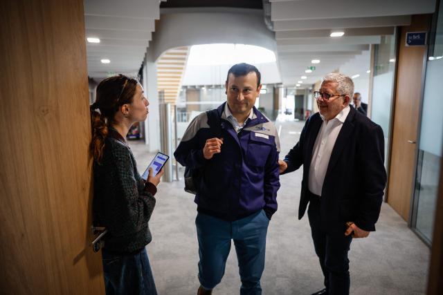 Director of the Stellantis Poissy plant Eric Haan (C) arrives to address media during a press conference at the Stellantis multinational car manufacturer's plant in Poissy, west of Paris on April 16, 2026. Automaker Stellantis will cease automobile production at its historic Poissy plant (Yvelines) after 2028. The site will be converted into a parts manufacturing and vehicle dismantling center, retaining 1,000 of the current 2,000 jobs, the group announced on April 16, 2026. (Photo by Simon Wohlfahrt / AFP)