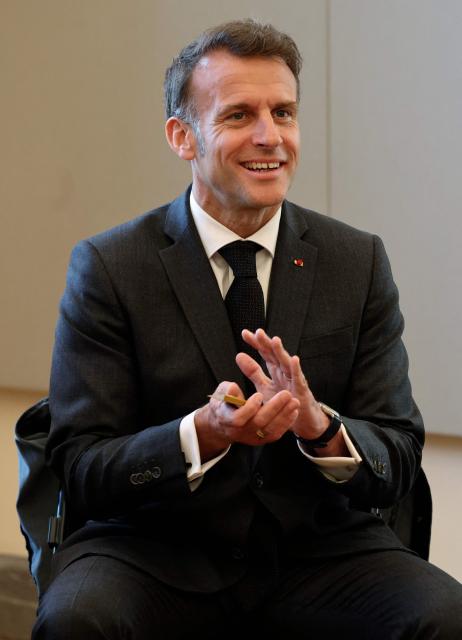 France's President Emmanuel Macron reacts as he listens to actors during a theater workshop at the International City of French Language (Cite Internationale de la Langue Francaise) to promote 'disconnecting' and 'reading' as alternatives to screens as part of his fight to ban social networks for the youngest in the castle of Villers-Cotterets, northern France on April 16, 2026. In response to the explosion in screen time among 6- to 17-year-olds and the impact of algorithms on our children, Emmanuel Macron has pledged to ban social media for those under 15. (Photo by Ludovic MARIN / POOL / AFP)