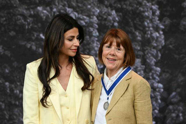 Frenchwoman Gisèle Pelicot, whose husband was convicted in 2024 of drugging her and letting scores of men rape her while unconscious, receives from the hand of Dutch fashion designer and entrepreneur Olcay Gulsen (L) the Freedom from Fear award during the Roosevelt Foundation's International Four Freedoms Awards ceremony in Middelburg on April 16, 2026. (Photo by NICOLAS TUCAT / AFP)