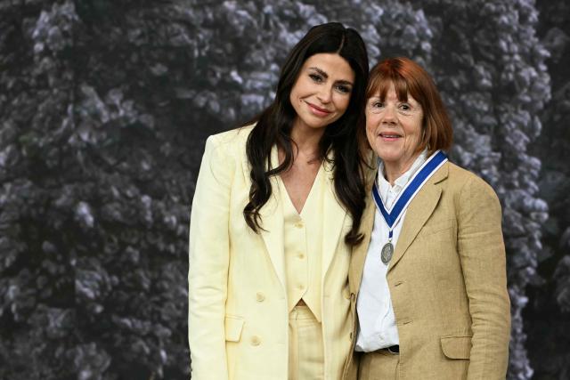 Frenchwoman Gisèle Pelicot, whose husband was convicted in 2024 of drugging her and letting scores of men rape her while unconscious, receives from the hand of Dutch fashion designer and entrepreneur Olcay Gulsen (L) the Freedom from Fear award during the Roosevelt Foundation's International Four Freedoms Awards ceremony in Middelburg on April 16, 2026. (Photo by NICOLAS TUCAT / AFP)