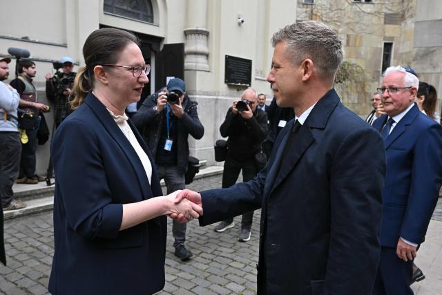 Hungary's Prime minister-elect Peter Magyar (R) is welcomed by Israel's ambassador to Hungary Maya Kadosh (L) as he arrives to attend a commemoration ceremony to mark the 82th anniversary of Hungarian Holocaust victims at the Holocaust Memorial Center in Budapest, Hungary on April 16, 2026. April 16, 2026 marks the 82th anniversary of the beginning of the Hungarian Holocaust during which some 600,000 Jewish Hungarians were deported to Nazi death camps in Austria, Germany and Poland. The Memorial Day of the Hungarian Victims of the Holocaust was established by the Ministry of Education in 2000 and is commemorated in schools, at memorial sites and by Jewish communities throughout the country. (Photo by Attila KISBENEDEK / AFP)