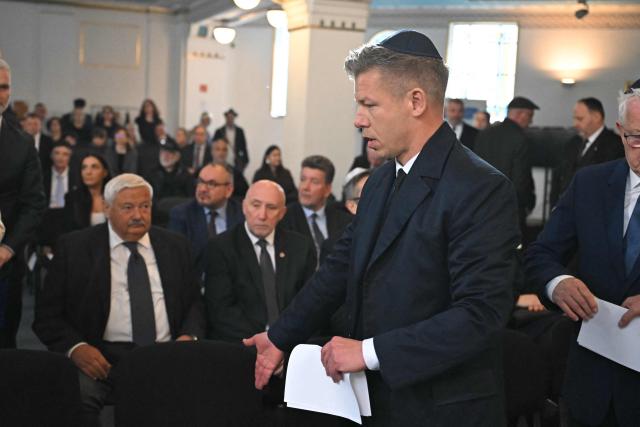 Hungary's Prime minister-elect Peter Magyar arrives to attend a commemoration ceremony to mark the 82th anniversary of Hungarian Holocaust victims at the Holocaust Memorial Center in Budapest, Hungary on April 16, 2026. April 16, 2026 marks the 82th anniversary of the beginning of the Hungarian Holocaust during which some 600,000 Jewish Hungarians were deported to Nazi death camps in Austria, Germany and Poland. The Memorial Day of the Hungarian Victims of the Holocaust was established by the Ministry of Education in 2000 and is commemorated in schools, at memorial sites and by Jewish communities throughout the country. (Photo by Attila KISBENEDEK / AFP)