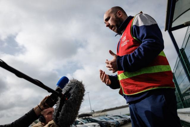 Jonathan Dos Santos, CGT union representative addresses media at the Stellantis multinational car manufacturer's plant in Poissy, west of Paris, on April 16, 2026. Automaker Stellantis will cease automobile production at its historic Poissy plant (Yvelines) after 2028. The site will be converted into a parts manufacturing and vehicle dismantling center, retaining 1,000 of the current 2,000 jobs, the group announced on April 16, 2026. (Photo by Simon Wohlfahrt / AFP)