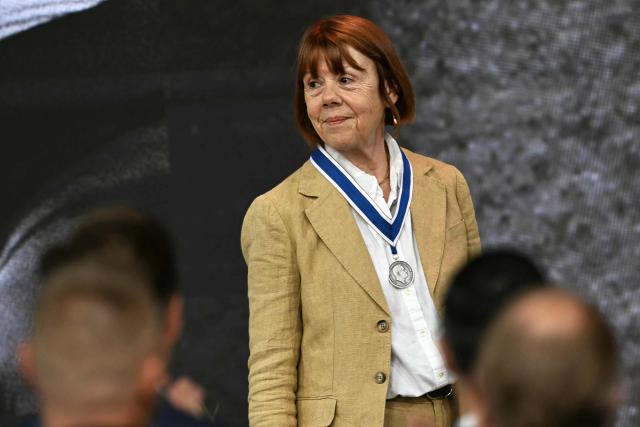 Frenchwoman Gisèle Pelicot, whose husband was convicted in 2024 of drugging her and letting scores of men rape her while unconscious, thanks attendees after receiving the Freedom from Fear award during the Roosevelt Foundation's International Four Freedoms Awards ceremony in Middelburg on April 16, 2026. (Photo by NICOLAS TUCAT / AFP)