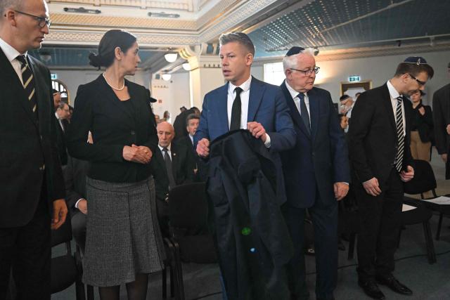 Hungary's Prime minister-elect Peter Magyar arrives to attend a commemoration ceremony to mark the 82th anniversary of Hungarian Holocaust victims at the Holocaust Memorial Center in Budapest, Hungary on April 16, 2026. April 16, 2026 marks the 82th anniversary of the beginning of the Hungarian Holocaust during which some 600,000 Jewish Hungarians were deported to Nazi death camps in Austria, Germany and Poland. The Memorial Day of the Hungarian Victims of the Holocaust was established by the Ministry of Education in 2000 and is commemorated in schools, at memorial sites and by Jewish communities throughout the country. (Photo by Attila KISBENEDEK / AFP)