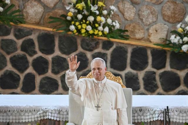 Pope Leo XIV waves as he arrives at Saint Joseph's Cathedral in Bamenda, on the fourth day of an 11-day apostolic journey to Africa, on April 16, 2026. (Photo by Alberto PIZZOLI / AFP)