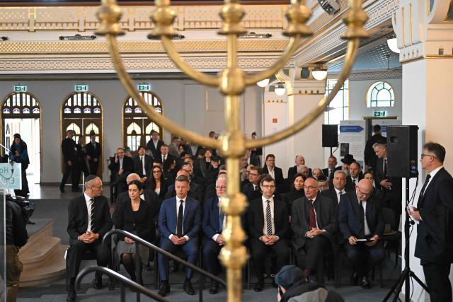 Hungary's Prime minister-elect Peter Magyar (3rdL) attends a commemoration ceremony to mark the 82th anniversary of Hungarian Holocaust victims at the Holocaust Memorial Center in Budapest, Hungary on April 16, 2026. April 16, 2026 marks the 82th anniversary of the beginning of the Hungarian Holocaust during which some 600,000 Jewish Hungarians were deported to Nazi death camps in Austria, Germany and Poland. The Memorial Day of the Hungarian Victims of the Holocaust was established by the Ministry of Education in 2000 and is commemorated in schools, at memorial sites and by Jewish communities throughout the country. (Photo by Attila KISBENEDEK / AFP)