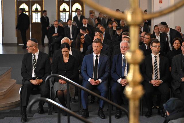 Hungary's Prime minister-elect Peter Magyar (3rdL) attends a commemoration ceremony to mark the 82th anniversary of Hungarian Holocaust victims at the Holocaust Memorial Center in Budapest, Hungary on April 16, 2026. April 16, 2026 marks the 82th anniversary of the beginning of the Hungarian Holocaust during which some 600,000 Jewish Hungarians were deported to Nazi death camps in Austria, Germany and Poland. The Memorial Day of the Hungarian Victims of the Holocaust was established by the Ministry of Education in 2000 and is commemorated in schools, at memorial sites and by Jewish communities throughout the country. (Photo by Attila KISBENEDEK / AFP)