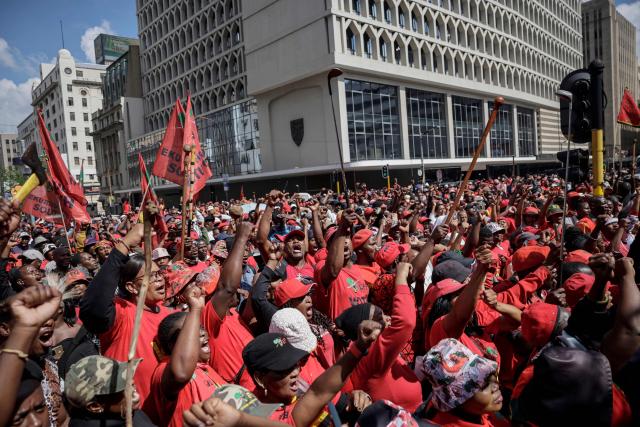 Supporters of the Economic Freedom Fighters (EFF) leader Julius Malema gather in Johannesburg on April 16, 2026 as they react to a ruling by a South African court in KuGompo, formerly called East London, that sentenced him to five years in jail for firing an assault rifle at a rally eight years ago. (Photo by Phill MAGAKOE / AFP)