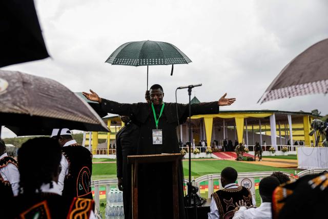 A man gestures as they wait for Pope Leo XIV to arrive to lead the Holy Mass at Bamenda Airport in Bamenda, on the fourth day of an 11-day apostolic journey to Africa, on April 16, 2026. (Photo by Patrick MEINHARDT / AFP)