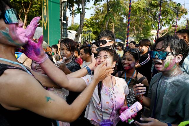 People play with powder during celebrations for the Khmer New Year, known as Nokor Sankranta, in Phnom Penh on April 16, 2026. (Photo by TANG CHHIN Sothy / AFP)