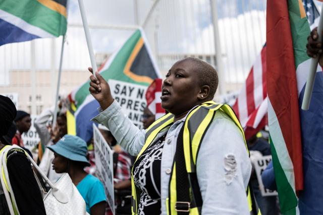 A protester who is pro-democracy for Iran waves the South African national flag during a protest in front of the US Consulate in Sandton, on April 16, 2026. (Photo by ILARIA FINIZIO / AFP)
