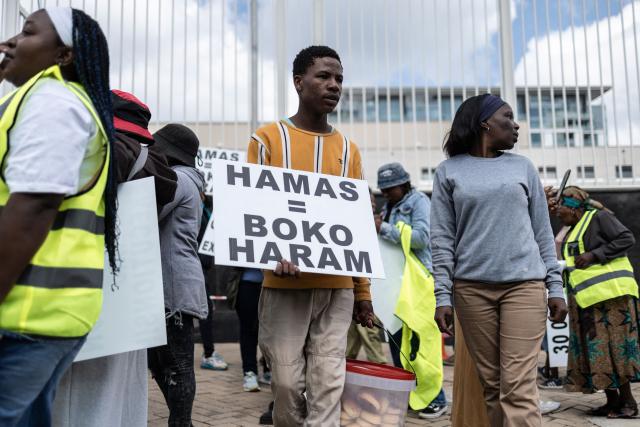 A protester who is pro-democracy for Iran holds a placard during a protest in front of the US Consulate in Sandton, on April 16, 2026. (Photo by ILARIA FINIZIO / AFP)