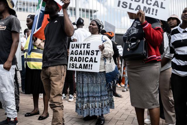 Protesters who are pro-democracy for Iran hold placards during a protest in front of the US Consulate in Sandton, on April 16, 2026. (Photo by ILARIA FINIZIO / AFP)