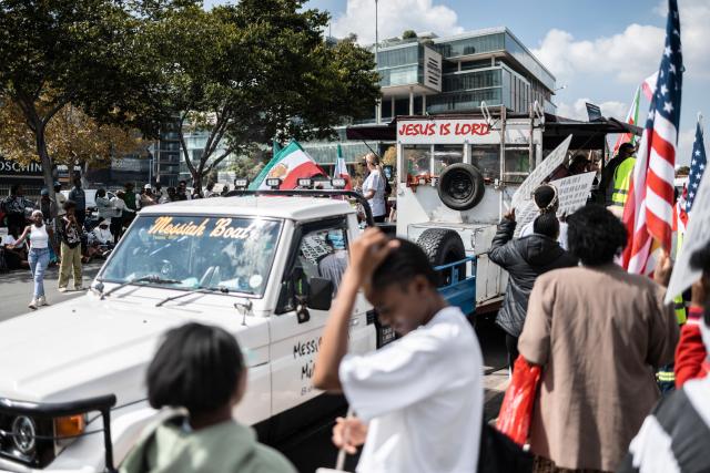 Protesters who are pro-democracy for Iran protest in front of the US Consulate in Sandton, on April 16, 2026. (Photo by ILARIA FINIZIO / AFP)
