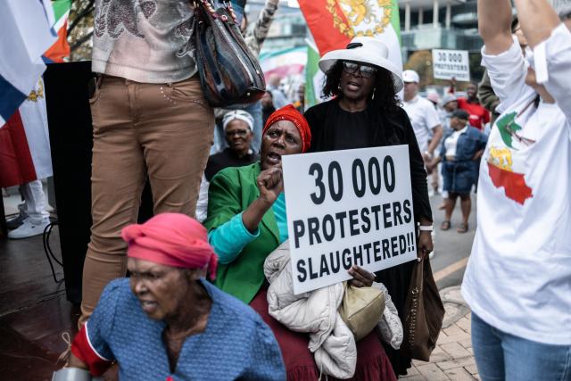 Protesters who are pro-democracy for Iran hold placards during a protest in front of the US Consulate in Sandton, on April 16, 2026. (Photo by ILARIA FINIZIO / AFP)
