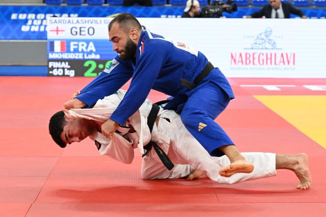 Georgia's Giorgi Sardalashvili (white) and France's Luka Mkheidze compete in the men's under 60 kg category gold medal bout at the Judo European Senior Championships 2026 in Tbilisi on April 16, 2026. (Photo by Vano SHLAMOV / AFP)