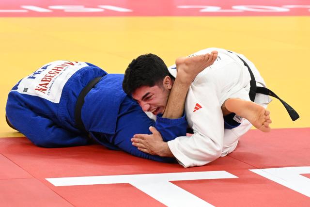 Georgia's Giorgi Sardalashvili (white) and France's Luka Mkheidze compete in the men's under 60 kg category gold medal bout at the Judo European Senior Championships 2026 in Tbilisi on April 16, 2026. (Photo by Vano SHLAMOV / AFP)