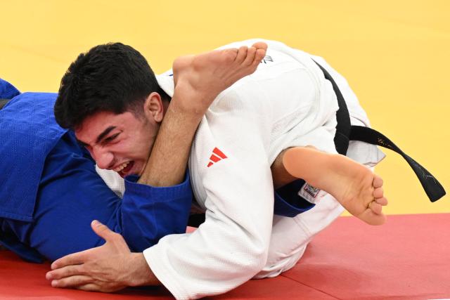 Georgia's Giorgi Sardalashvili (white) and France's Luka Mkheidze compete in the men's under 60 kg category gold medal bout at the Judo European Senior Championships 2026 in Tbilisi on April 16, 2026. (Photo by Vano SHLAMOV / AFP)
