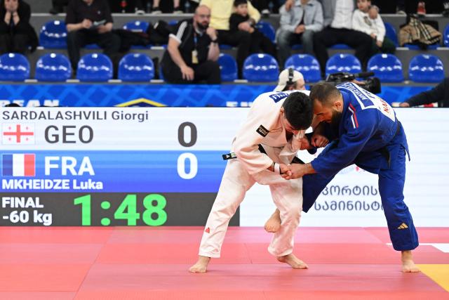 Georgia's Giorgi Sardalashvili (white) and France's Luka Mkheidze compete in the men's under 60 kg category gold medal bout at the Judo European Senior Championships 2026 in Tbilisi on April 16, 2026. (Photo by Vano SHLAMOV / AFP)