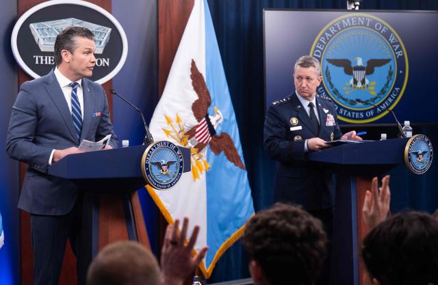 (L/R) US Secretary of Defense Pete Hegseth speaks alongside Chairman of the Joint Chiefs of Staff General Dan Caine during a press briefing at the Pentagon in Washington, DC, on April 16, 2026. The United States will prevent all shipping from entering or exiting Iranian ports in the Strait of Hormuz for "as long as it takes," US Defense Secretary Pete Hegseth said on Thursday, the fourth day of the blockade. (Photo by SAUL LOEB / AFP)