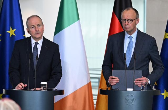 German Chancellor Friedrich Merz (R) and Ireland's Prime Minister Micheal Martin attend a press conference at the Chancellery in Berlin on April 16, 2026, after bilateral talks. (Photo by RALF HIRSCHBERGER / AFP)