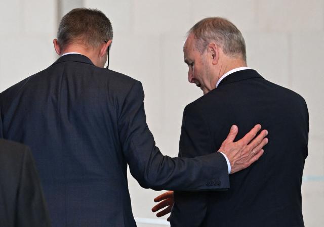 German Chancellor Friedrich Merz (L) and Ireland's Prime Minister Micheal Martin leave after a press conference at the Chancellery in Berlin on April 16, 2026, after bilateral talks. (Photo by RALF HIRSCHBERGER / AFP)