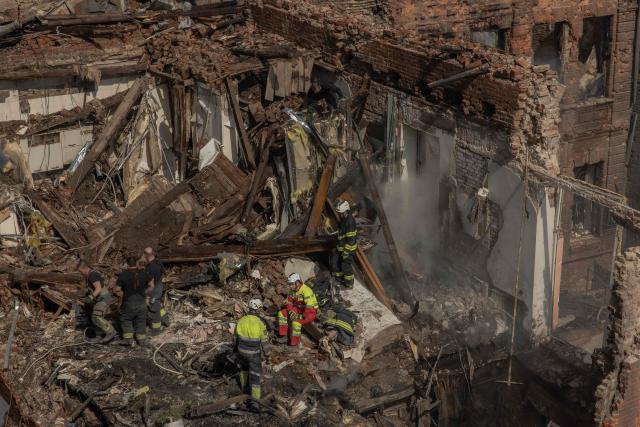 Ukrainian rescuers work at the site of heavily damaged buildings following a Russian air attack in Dnipro, on April 16, 2026, amid the Russian invasion of Ukraine. Massive Russian strikes on Ukraine left at least 19 people dead overnight from April 15 to April 16, particularly in Kyiv and Odesa, Ukrainian authorities said on April 16, 2026, describing these attacks as among the deadliest in recent weeks. (Photo by Roman PILIPEY / AFP)