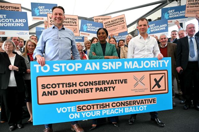 Britain's main opposition Conservative Party leader Kemi Badenoch (C) Shadow Secretary of State for Scotland Andrew Bowie (R) and Scottish Conservative leader Russell Findlay pose for a photo during a rally in Edinburgh, Scotland on April 16, 2026, to highlight the importance of voting in upcoming elections. (Photo by ANDY BUCHANAN / AFP)