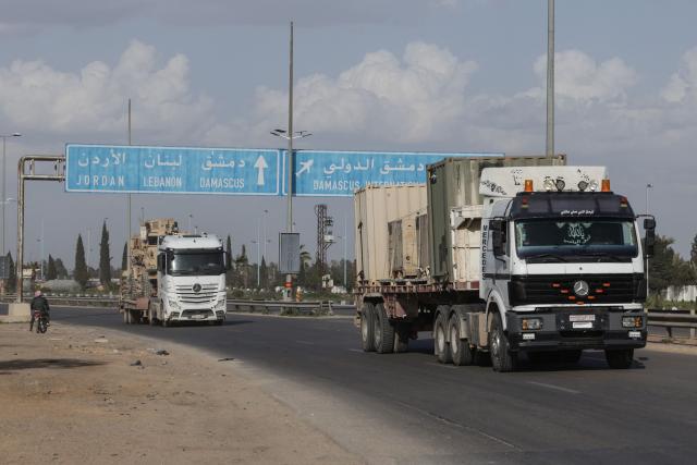 A convoy of US military equipment is transported along the DamascusAmman highway toward the southwestern city of Daraa, following the completion of the US withdrawal from their bases, as it travels near the capital Damascus on April 16, 2026. Syria said on April 16, it had taken control of all military bases hosting US troops who were deployed in the country for years leading an international coalition against the Islamic State (IS) group. In recent months, Syria's new Islamist government has expanded its control to parts of the country's northeast that were previously held by US-allied Kurdish forces, while the government has also formally joined the international anti-IS coalition. (Photo by Bakr ALkasem / AFP)