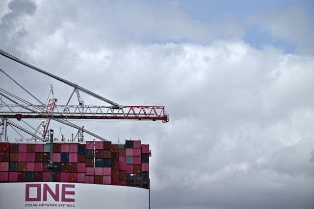 The One Inspiration cargo ship, registered under the flag of Liberia, is seen during loading at the container terminal of Southampton Docks in Southampton on the south coast of England on April 16, 2026. Britain's economy grew much stronger than expected in February, prior to the start of the Middle East war, official data showed on April 16, ahead of a likely hit from the US-Iran conflict. UK gross domestic product growth climbed to 0.5 percent in February compared with expansion of 0.1 percent in January, the Office for National Statistics said in a statement. (Photo by Ben STANSALL / AFP)