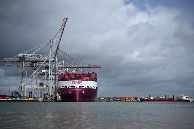 The One Inspiration cargo ship, registered under the flag of Liberia, is seen during loading at the container terminal of Southampton Docks in Southampton on the south coast of England on April 16, 2026. Britain's economy grew much stronger than expected in February, prior to the start of the Middle East war, official data showed on April 16, ahead of a likely hit from the US-Iran conflict. UK gross domestic product growth climbed to 0.5 percent in February compared with expansion of 0.1 percent in January, the Office for National Statistics said in a statement. (Photo by Ben STANSALL / AFP)