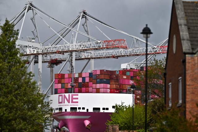 The One Inspiration cargo ship, registered under the flag of Liberia, is seen during loading at the container terminal of Southampton Docks in Southampton on the south coast of England on April 16, 2026. Britain's economy grew much stronger than expected in February, prior to the start of the Middle East war, official data showed on April 16, ahead of a likely hit from the US-Iran conflict. UK gross domestic product growth climbed to 0.5 percent in February compared with expansion of 0.1 percent in January, the Office for National Statistics said in a statement. (Photo by Ben STANSALL / AFP)