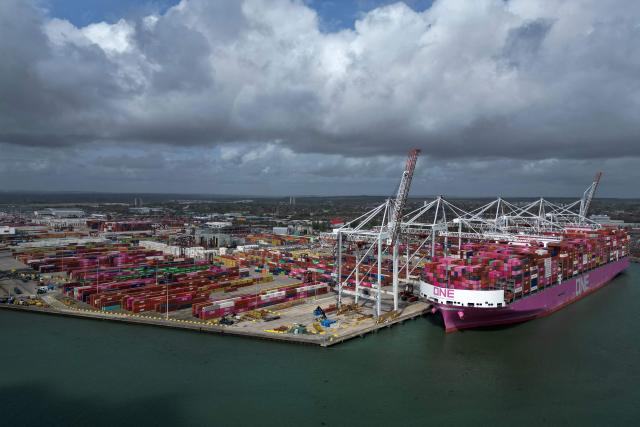 An aerial picture shows freight containers on the dock as ship to shore cranes load the One Inspiration cargo ship, registered under the flag of Liberia, at the container terminal of Southampton Docks in Southampton on the south coast of England on April 16, 2026. Britain's economy grew much stronger than expected in February, prior to the start of the Middle East war, official data showed on April 16, ahead of a likely hit from the US-Iran conflict. UK gross domestic product growth climbed to 0.5 percent in February compared with expansion of 0.1 percent in January, the Office for National Statistics said in a statement. (Photo by Ben STANSALL / AFP)