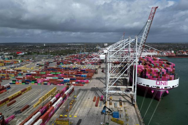 An aerial picture shows freight containers on the dock as ship to shore cranes load the One Inspiration cargo ship, registered under the flag of Liberia, at the container terminal of Southampton Docks in Southampton on the south coast of England on April 16, 2026. Britain's economy grew much stronger than expected in February, prior to the start of the Middle East war, official data showed on April 16, ahead of a likely hit from the US-Iran conflict. UK gross domestic product growth climbed to 0.5 percent in February compared with expansion of 0.1 percent in January, the Office for National Statistics said in a statement. (Photo by Ben STANSALL / AFP)
