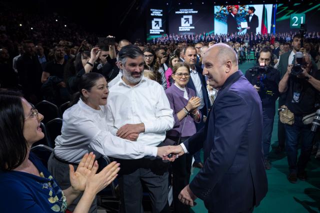 Former Bulgaria's president Rumen Radev (centre R) shakes hands with supporters during the final pre-election event of his political coalition "Progressive Bulgaria" in Sofia on April 16, 2026. Bulgaria will hold its eighth general election in five years on April 19, 2026, with ex-president Rumen Radev's new grouping tipped to win a ballot many hope will end chronic instability. (Photo by Nikolay DOYCHINOV / AFP)