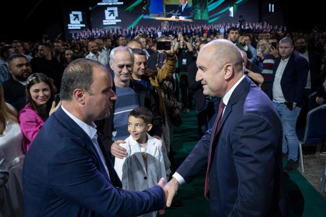 Former Bulgaria's president Rumen Radev (centre R) shakes hands with supporters during the final pre-election event of his political coalition "Progressive Bulgaria" in Sofia on April 16, 2026. Bulgaria will hold its eighth general election in five years on April 19, 2026, with ex-president Rumen Radev's new grouping tipped to win a ballot many hope will end chronic instability. (Photo by Nikolay DOYCHINOV / AFP)