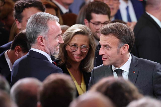 Paris Mayor Emmanuel Gregoire (L) speaks with  France's President Emmanuel Macron  during a reception organized for 500 mayors from across the political spectrum and from every part of the country, to 'support' and 'mobilize' these 'alveoli of the nation's democratic lungs', one month after France's municipal elections at the presidential Elysee Palace in Paris on April 16, 2026. (Photo by Ludovic MARIN / POOL / AFP)