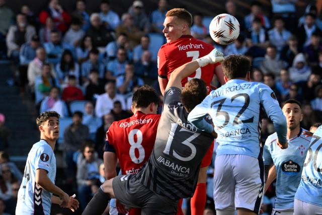 Freiburg's Austrian defender #03 Philipp Lienhart jumps for a header as Celta Vigo's Romanian goalkeeper #13 Ionut Andrei Radu clears the ball during the UEFA Europa League quarter final second leg football match between RC Celta de Vigo and SC Freiburg at Balaidos Stadium in Vigo on April 16, 2026. (Photo by Miguel RIOPA / AFP)