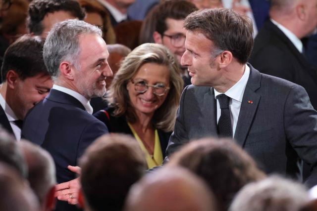 Paris Mayor Emmanuel Gregoire (L) speaks with  France's President Emmanuel Macron  during a reception organized for 500 mayors from across the political spectrum and from every part of the country, to 'support' and 'mobilize' these 'alveoli of the nation's democratic lungs', one month after France's municipal elections at the presidential Elysee Palace in Paris on April 16, 2026. (Photo by Ludovic MARIN / POOL / AFP)